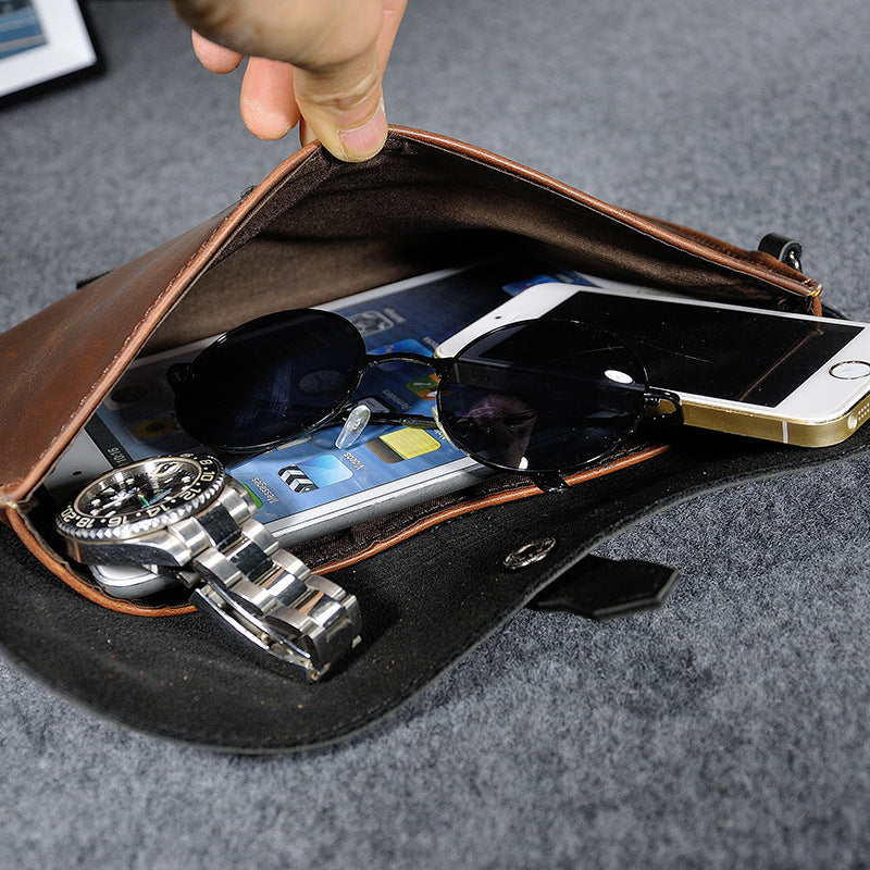 Open clutch showing a phone, watch and other styling items inside