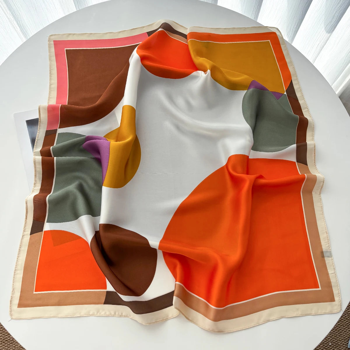 Multicolor square scarf with orange, cream, brown and green geometric shapes