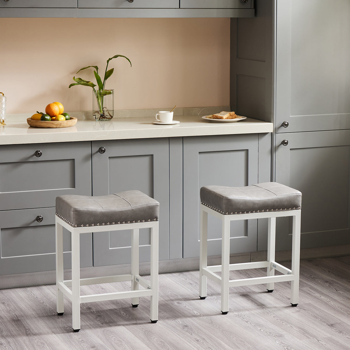 Two gray counter stools beside a kitchen island
