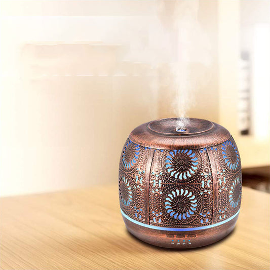 Floral aroma diffuser with blue light on a wooden tabletop