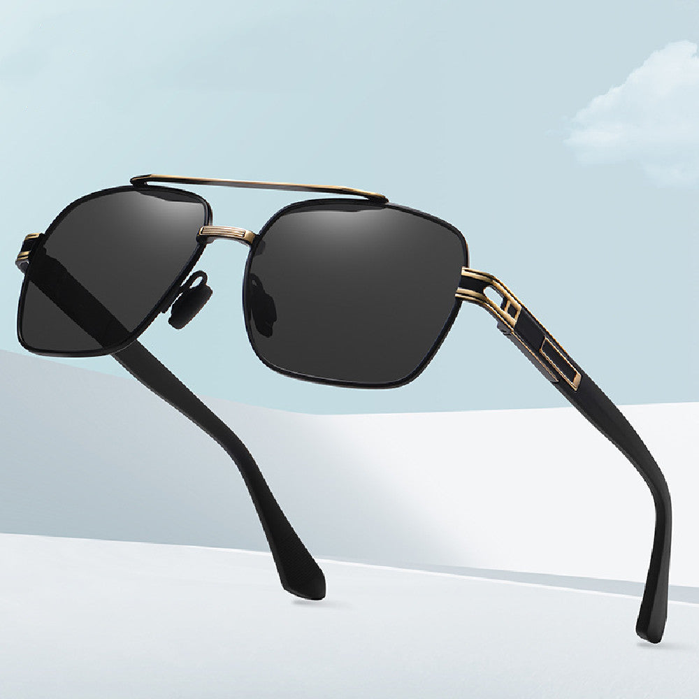 Black rectangular fashion glasses with gold-tone details on a blue backdrop