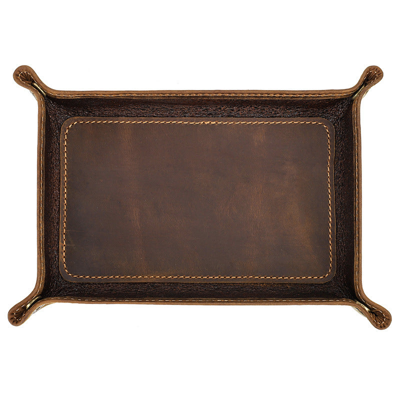 Empty brown valet tray showing the stitched base and raised corners