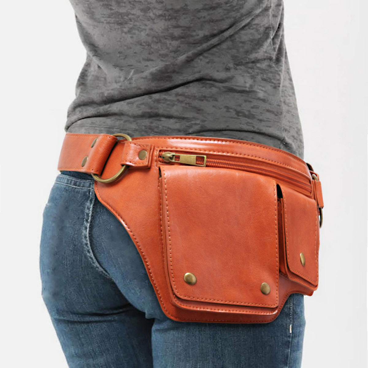 Brown utility waist bag worn with jeans