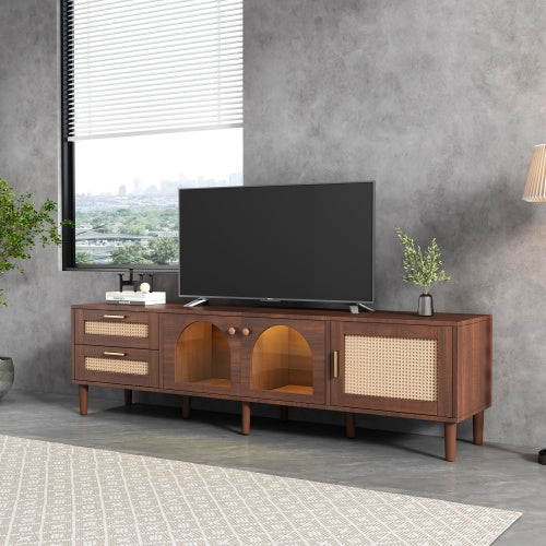 Woven-look media console beneath a TV beside a large window