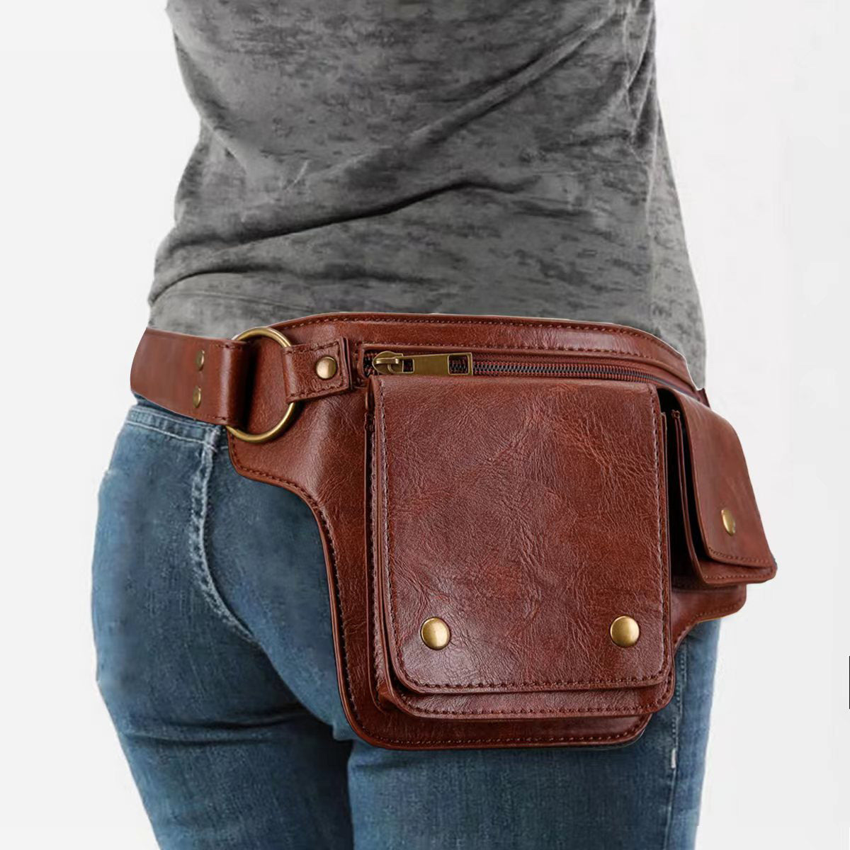 Reddish brown utility waist bag worn with jeans