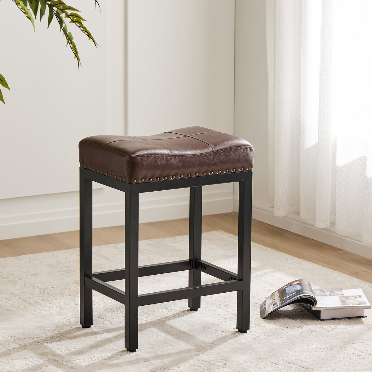 Single brown upholstered counter stool beside a window