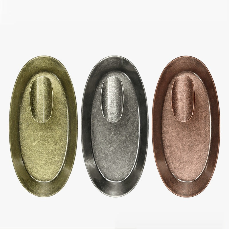 Three oval metal ashtrays in silver, bronze and copper-colored finishes