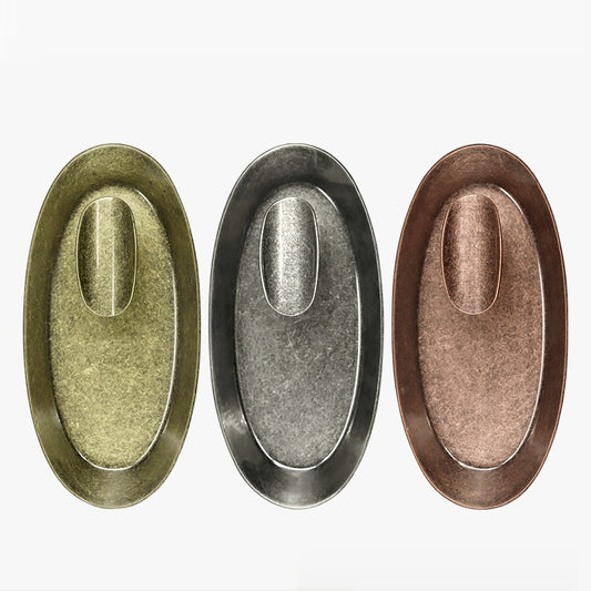 Three oval metal ashtrays in silver, bronze and copper-colored finishes