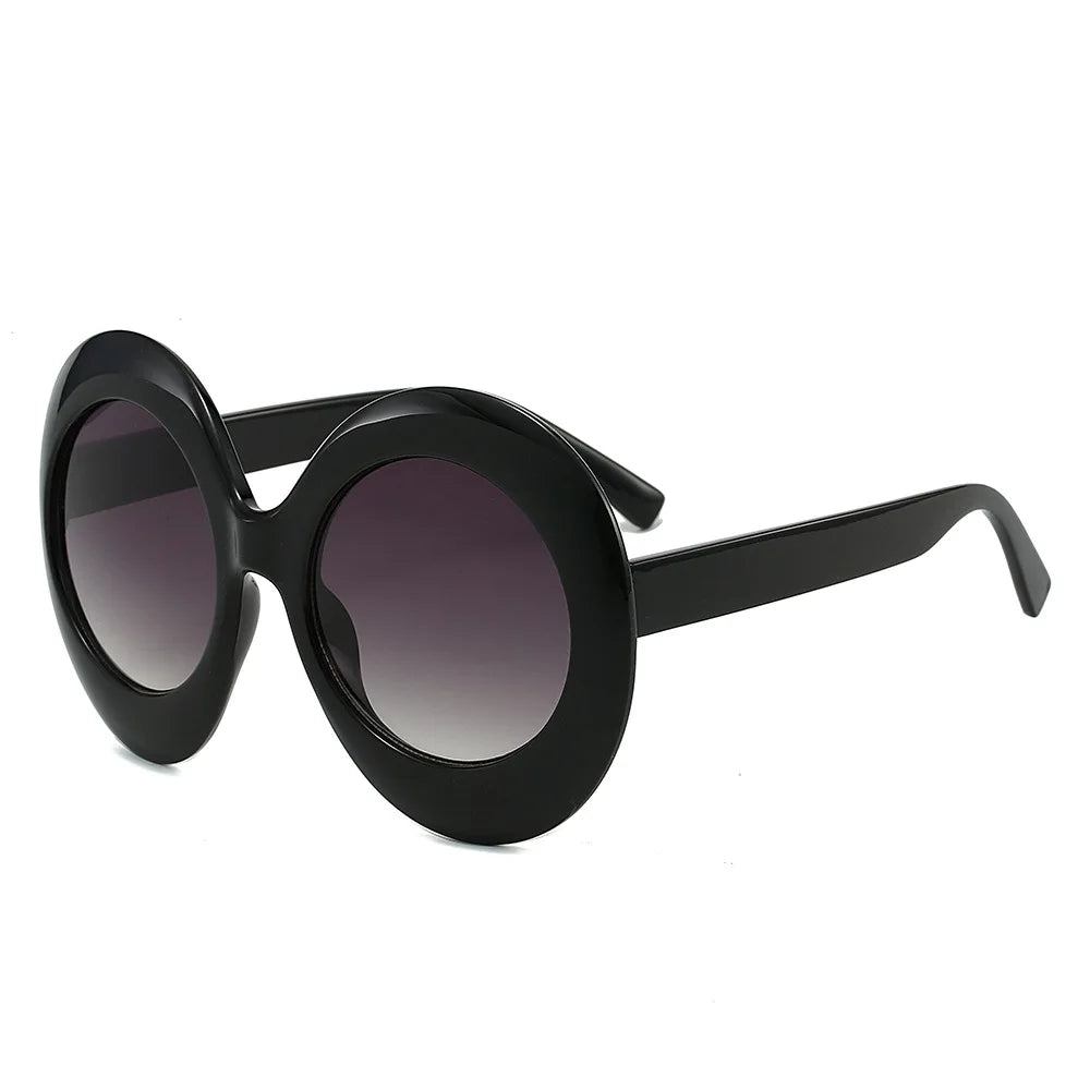 Oversized round black sunglasses with gradient lenses