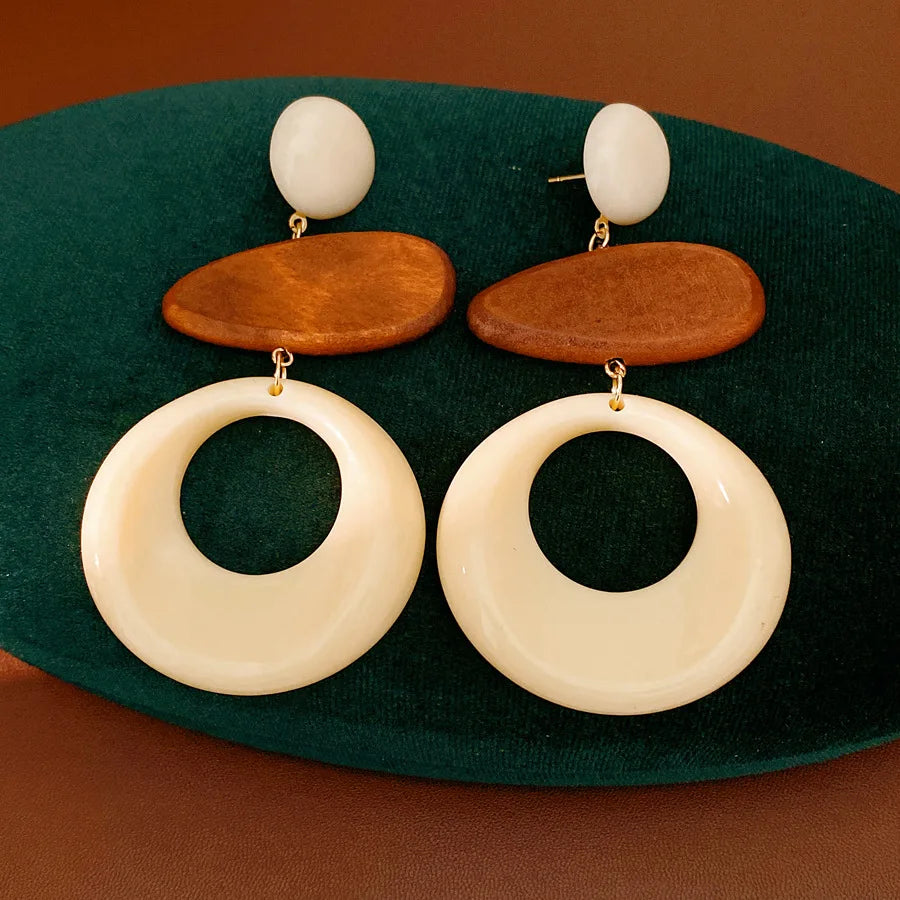 Pair of cream circular resin earrings with brown oval wood accents
