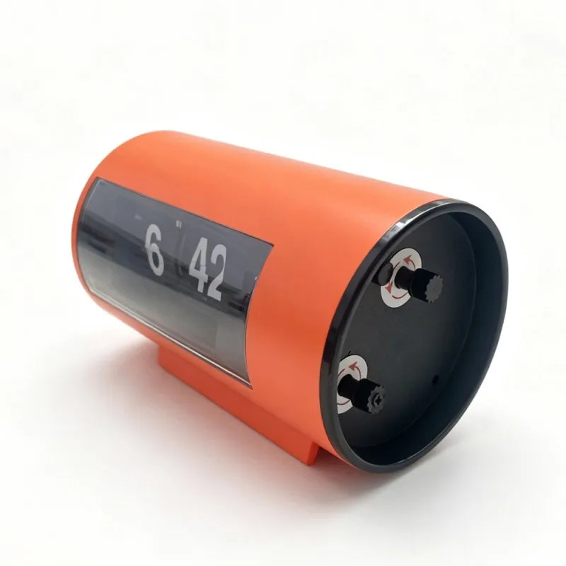 Side view of the orange clock showing its adjustment controls