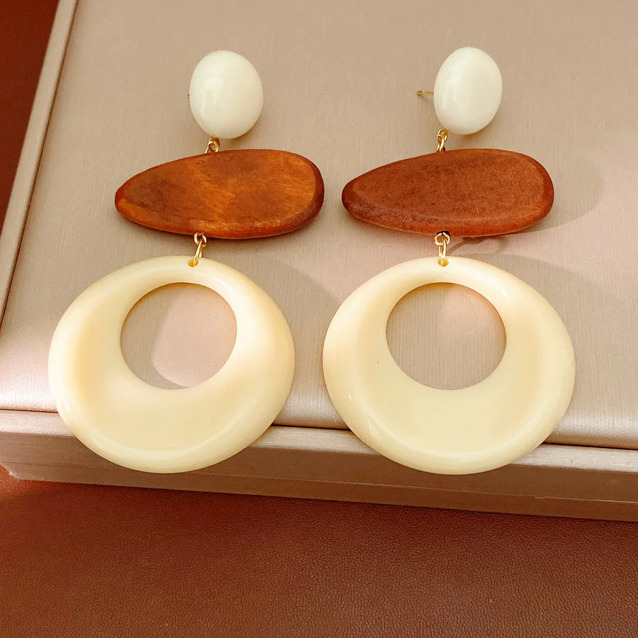 Cream circular resin earrings with brown oval wood accents