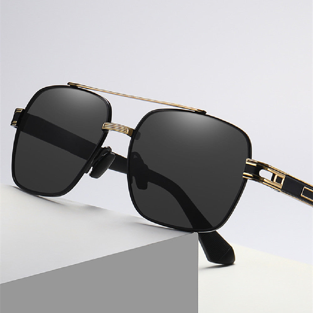 Front close-up of dark rectangular glasses with gold-tone detailing