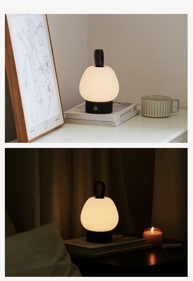 Pear table lamp shown on a shelf in daytime and in a dim room