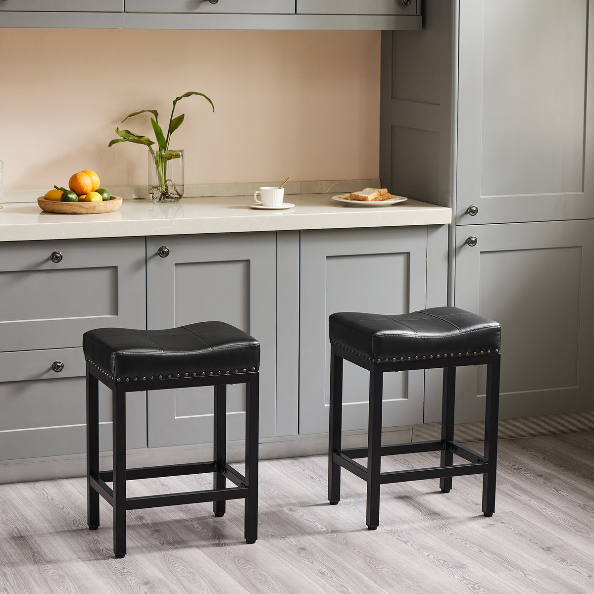 Two black counter stools beside a kitchen island