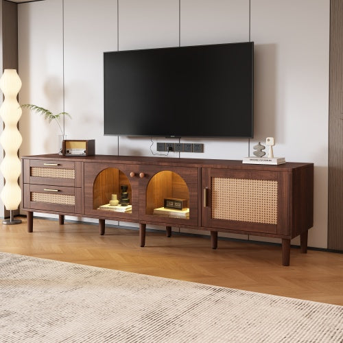 Dark brown woven-look media console with lit center cabinets below a TV