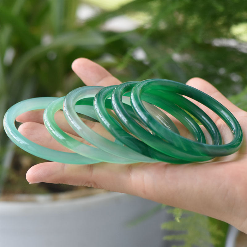 Green translucent bangles showing variation in shade